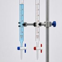 Two graduated glass burettes with PTFE stopcocks held in a clamp on a retort stand