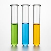 Three glass test tubes holding green, blue and orange liquids
